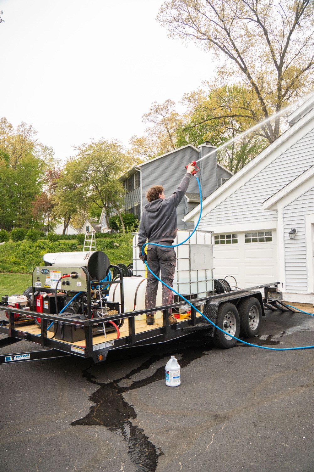 Elevation crew soft-washing a two-story home from their professional rig in the Grand Rapids metro